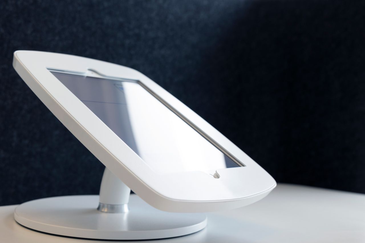 Close-up of a sleek tablet stand on a table, showcasing modern design in technology.